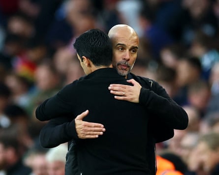 Pep Guardiola and Mikel Arteta hug it out.