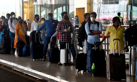 Passengers queue to enter Mumbai airport, as domestic air travel was lifted after two months on the ground due to the coronavirus pandemic. 