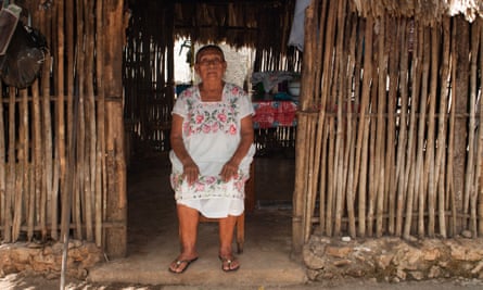 Luis Góngora’s mother, Estela, sits at the entrance to the traditional Mayan house where her son and his wife lived when they were first married.