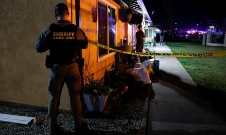 A sheriff's deputy puts up crime scene tape following a shooting at a church in Sacramento, California, February  2022.