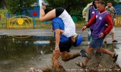 A man carries his wife over an obstacle while competing in the Wife Carrying Championship to mark City Day in Krasnoyarsk, Siberia, Russia, June 25, 2016. REUTERS/Ilya Naymushin