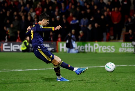 Arsenal's Kai Havertz scores a penalty during a penalty shootout.
