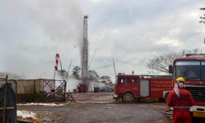 An Oil India Limited (OIL) firefighter oversees the oil well site following the 27 May blast at the Baghjan oil field.