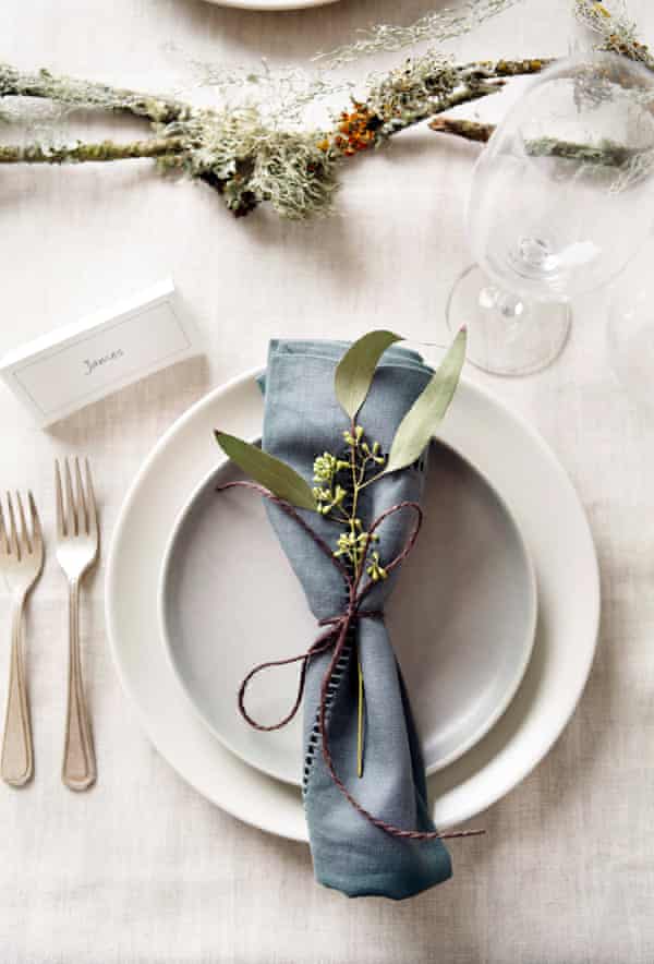 Place setting with blue napkin and foliage