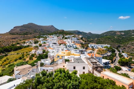 A village of white houses, with hills in the background