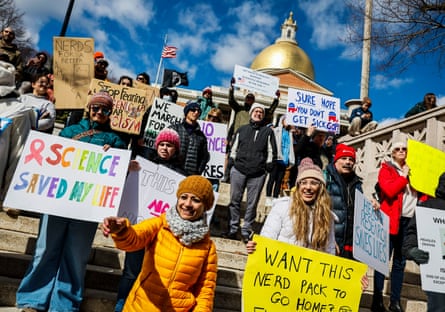 people clasp signs successful support of science