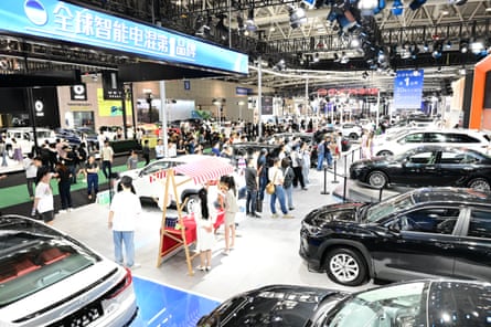 People walk around a car showroom