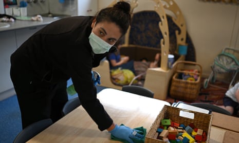 Early childhood educator Josephine wipes down tables and bench tops with disinfectant at the Robertson Street Kindy Childcare Centre in Helensburgh south of Sydney, 3 April 2020. 