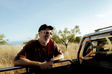 Aris Christopoulos leaning over the side rail of a pickup truck