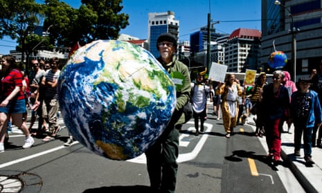 A man holding a large blow up globe participates in the march on New Zealand parliament in Wellington on Saturday to call for more action on climate change.