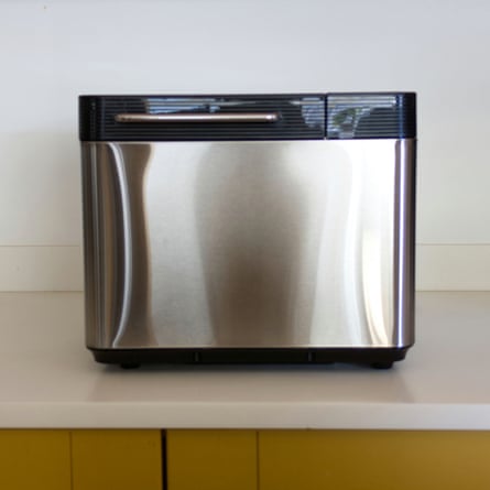A stainless steel Lakeland bread maker with a black top and handle sits on a kitchen counter
