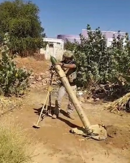 a soldier operates a mortar
