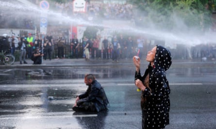 A protester blows bubbles