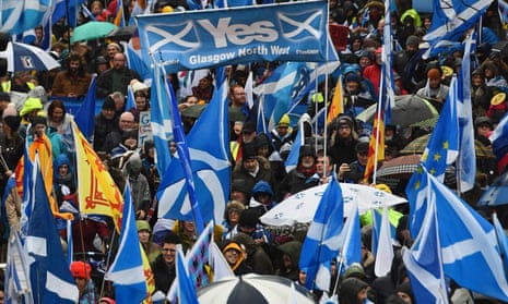 Protesters with Scottish Saltire flags attend the march organised by All Under One Banner calling for Scottish independence in Glasgow.