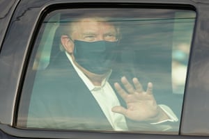 A car with Donald Trump drives past supporters outside Walter Reed in Bethesda, Maryland, on 4 October.