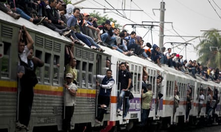 Commuters on the roof of train in Cawang, East Jakarta, in 2012. A crackdown has since stopped passengers roof riding and hanging from doors.