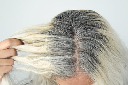 A blond woman with greying roots