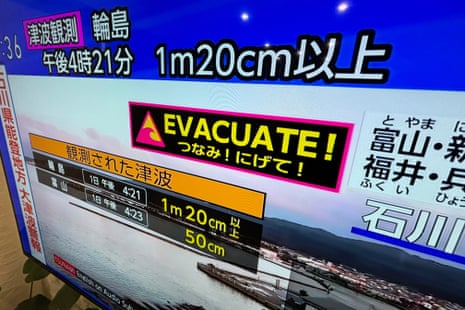 A tsunami warning is shown on TV in Yokohama, near Tokyo.