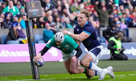Mack Hansen, challenged by Duhan van der Merwe, scores Ireland’s first try in this year’s Six Nations match against Scotland.
