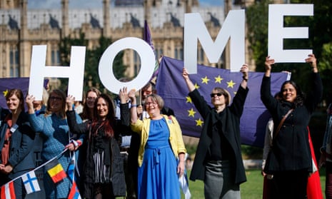 Demonstrators hold banners during a protest to Lobby MPs to guarantee the rights of EU citizens living in the UK.