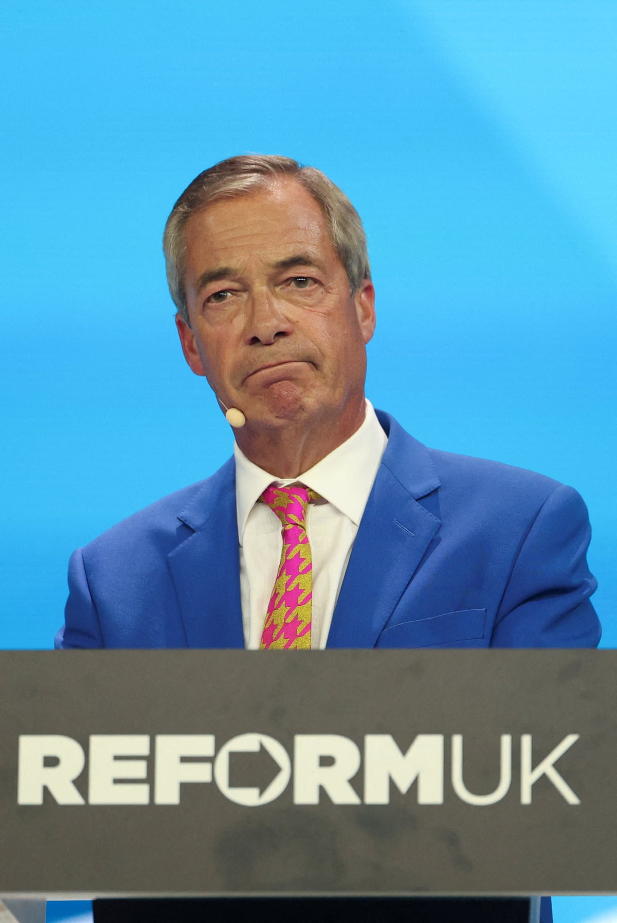 Nigel Farage speaking on stage.