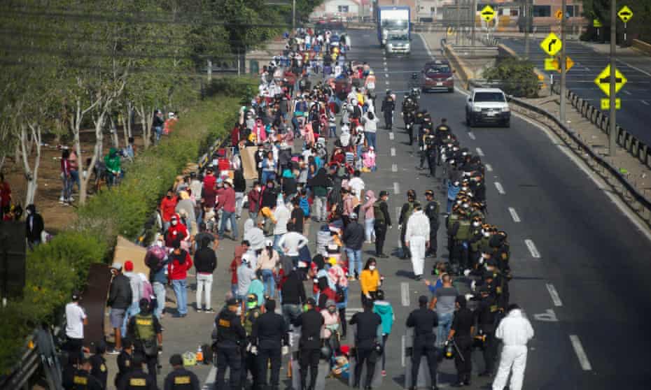Peruvians are stopped by riot police in Lima as they try to make their way to San Martin and other parts of the country on 18 April.