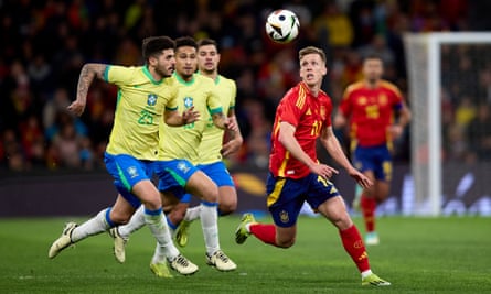Dani Olmo contests for the ball against Brazil.