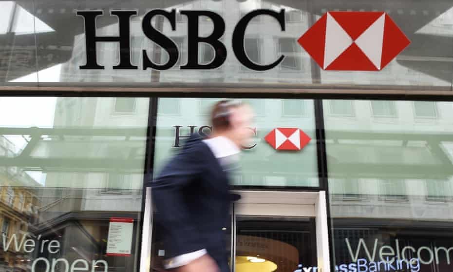 A pedestrian walking past a HSBC bank branch in London