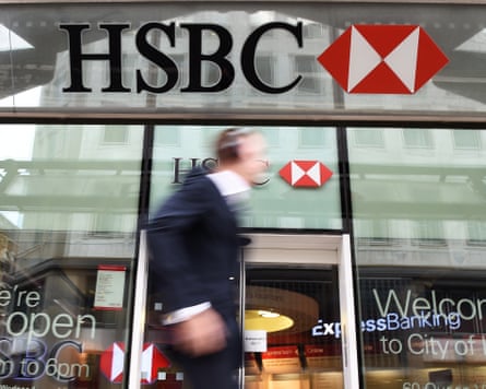 A pedestrian walking past a HSBC bank branch in London