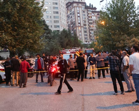 People gather in the street in Tehran on Friday morning in the wake of Israeli strikes on Iran.