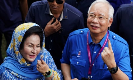 Najib Razak and his wife Rosmah Mansor show their ink-stained fingers after voting in Malaysia’s general election in 2018