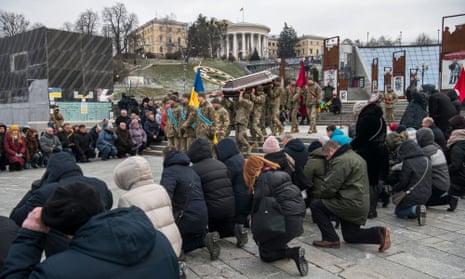 Relatives, friends and comrades attend the funeral ceremony for a Ukrainian officer who was killed in a battle against Russian troops near Bachmut town in Donetsk region.