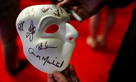 A fan holds a signed Phantom mask during the re-opening night of Phantom of the Opera in New York. but who wrote the original story?