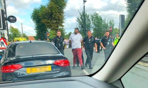 A man being detained by police after an incident in Moseley, Birmingham.