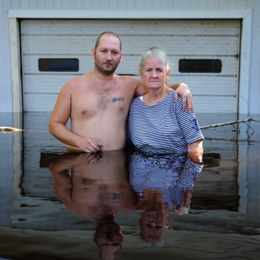 Gideon Mendel, Terrence Mckeen with his mother, Gloria, Middleburg Hurricane Irma caused huge amounts of flooding, death and destruction in its path.stand waist-deep in front of a half submerged building