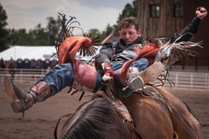 A man struggles to stay on a bucking horse