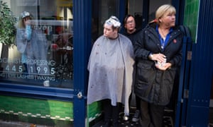 Govan locals turn out of shops, pubs and hairdressers to watch as a Cop26 demonstration goes by.