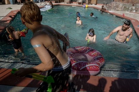 Children and parents play in a pool