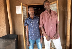 Michael Chaban (left), 30, and Jawell Amule (right), 19, stand outside their small ‘tech-hub’ in zone 5