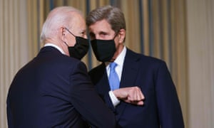 US president Joe Biden greets special presidential envoy for climate John Kerry as he arrives to speak on climate change before signing executive orders in the State Dining Room of the White House in Washington, DC on January 27, 2021.