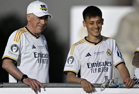 Arda Guler and the Real Madrid manager, Carlo Ancelotti, smile during the Champions League victory parade.