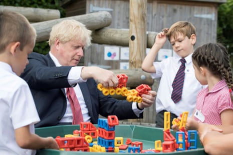 Britain’s Prime Minister Boris Johnson plays with toys as students look on during a visit to The Discovery School in Kent, Britain on 20 July, 2020.