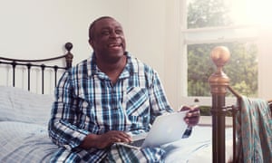 Dotun Adebayo in bed with his laptop