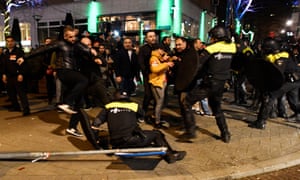 Riot police clash with demonstrators in the streets near the Turkish consulate in Rotterdam in the early hours of Sunday.