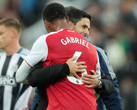 Gabriel and Mikel Arteta embrace after the Premier League match between Newcastle and Arsenal