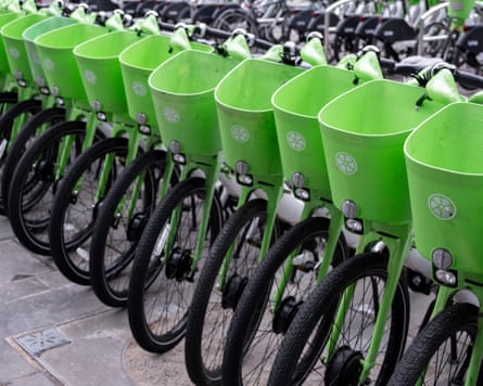Lime electric bicycles parked in a line across the pavement in London