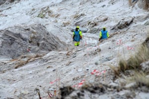 Zimbabweans work on a mined beach in Stanley