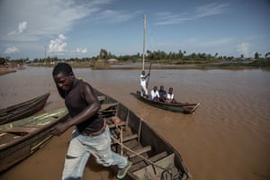 A man jumps from a boat in flooded Busia county.