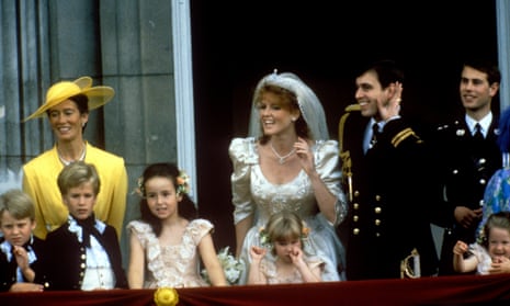 Prince Andrew and Sarah Ferguson in a wedding gown, standing on the Buckingham Palace balcony waving, surrounded by children