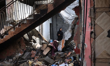 A Palestinian woman surveys the damage to a house following Israeli bombardment at the al-Maghazi Palestinian refugee camp, in the central Gaza Strip on 15 July 2024, amid the ongoing conflict between Israel and the Palestinian Hamas militant group.